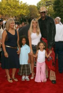 Image of Dennis Rodman with his wife and kids